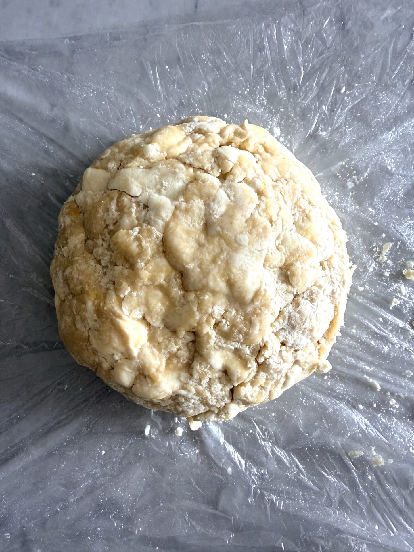 IMG_8416 A ball of pastry dough is seen after it has rested and chilled in the swift. The image shows a tighter, smoother shape than previously seen with the fresh dough.