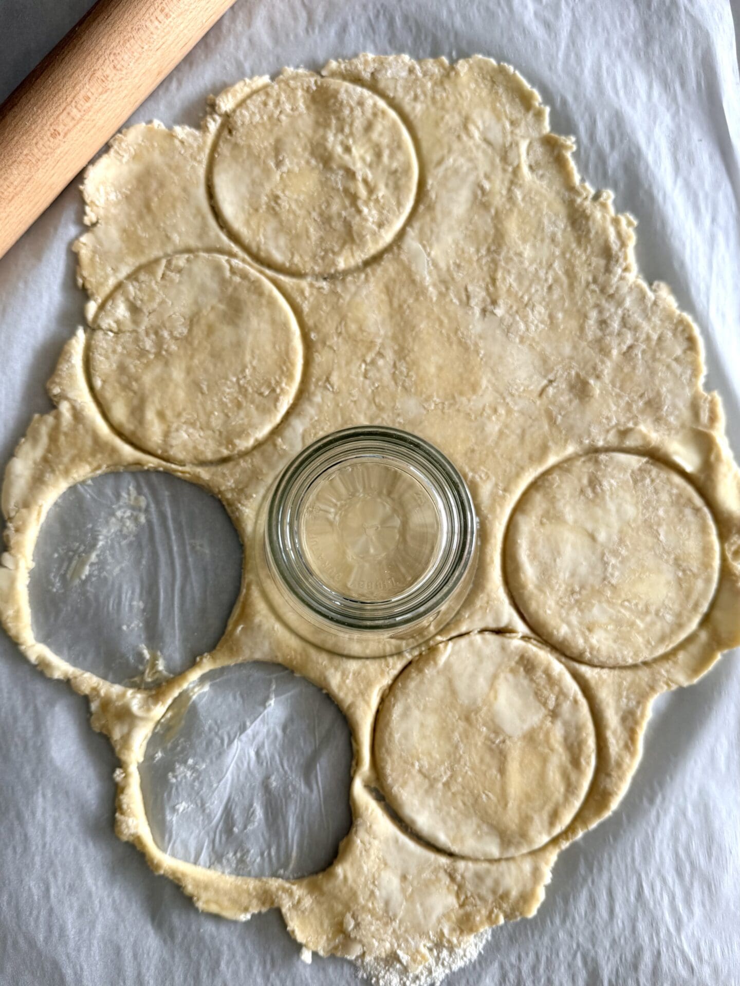 IMG_8421 Rounds of pastry are being cut out for butter tarts, using a drinking glass as a cutter.