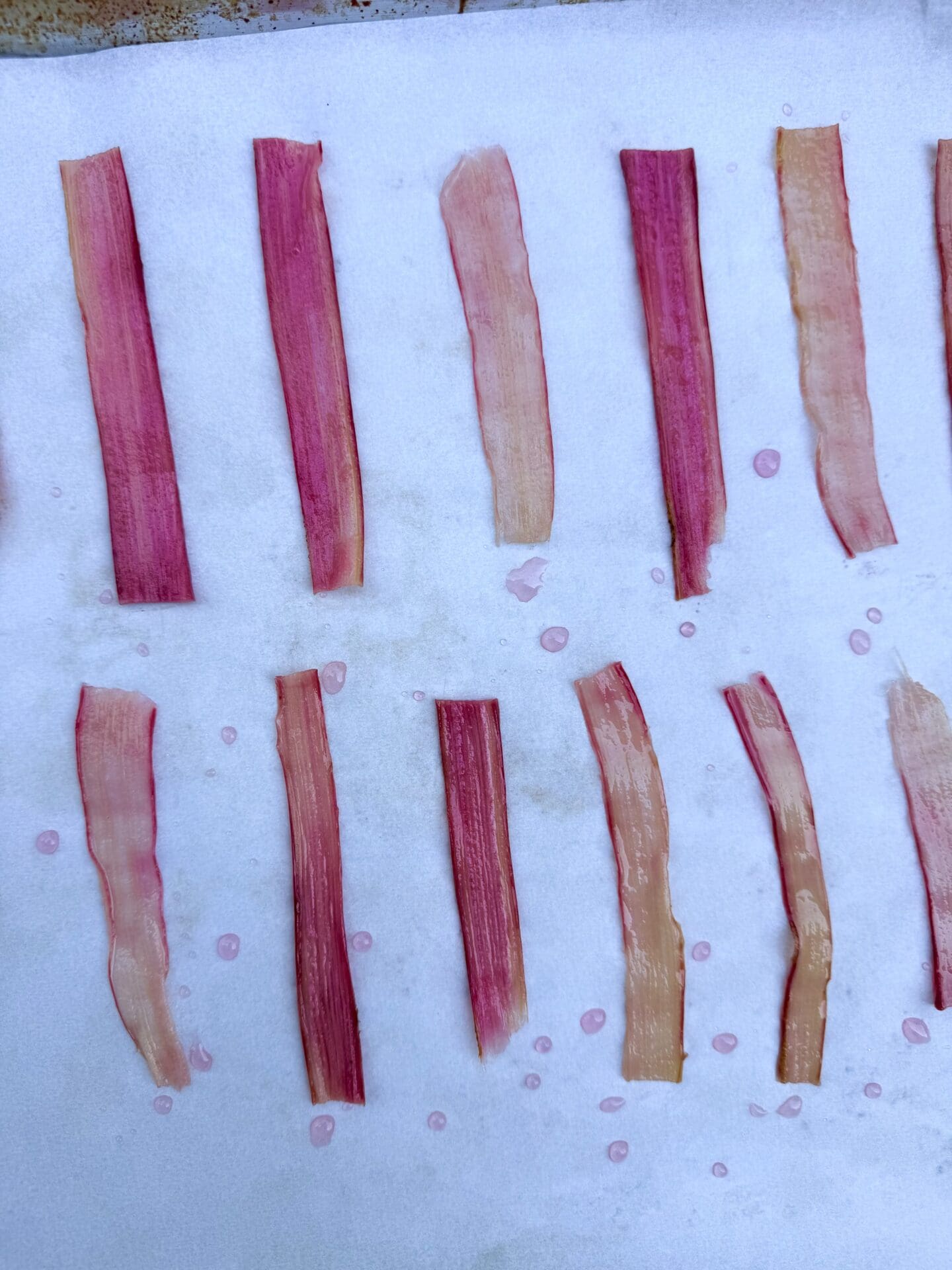 Strips of rhubarb are oven dried in the process of making Candied Rhubarb Ribbons.