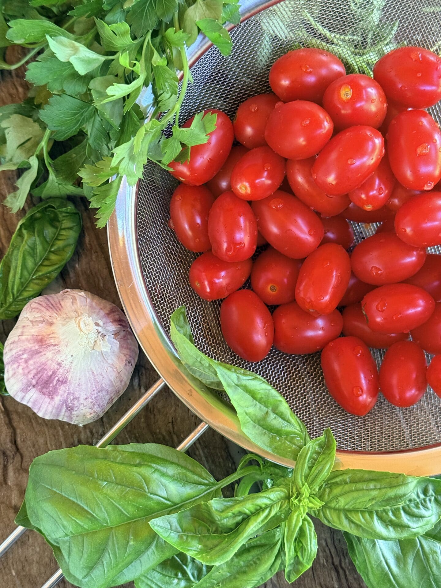 The ingredients for marinated cherry tomatoes are seen before recipe preparation begins.