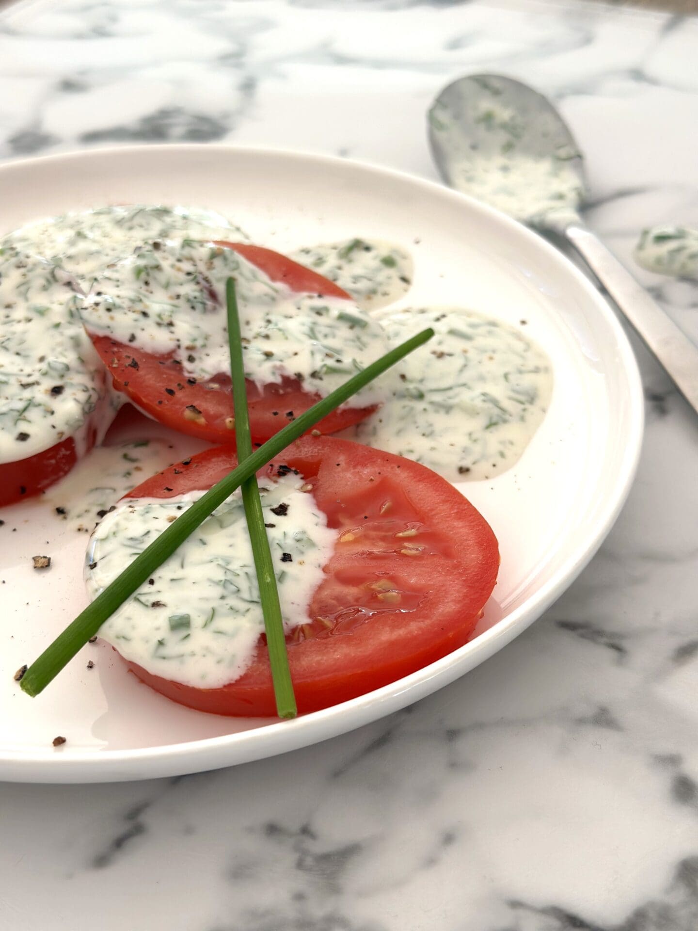 IMG_9380 Plate of tomato slices with generous dollops of homemade buttermilk and herb ranch dressing