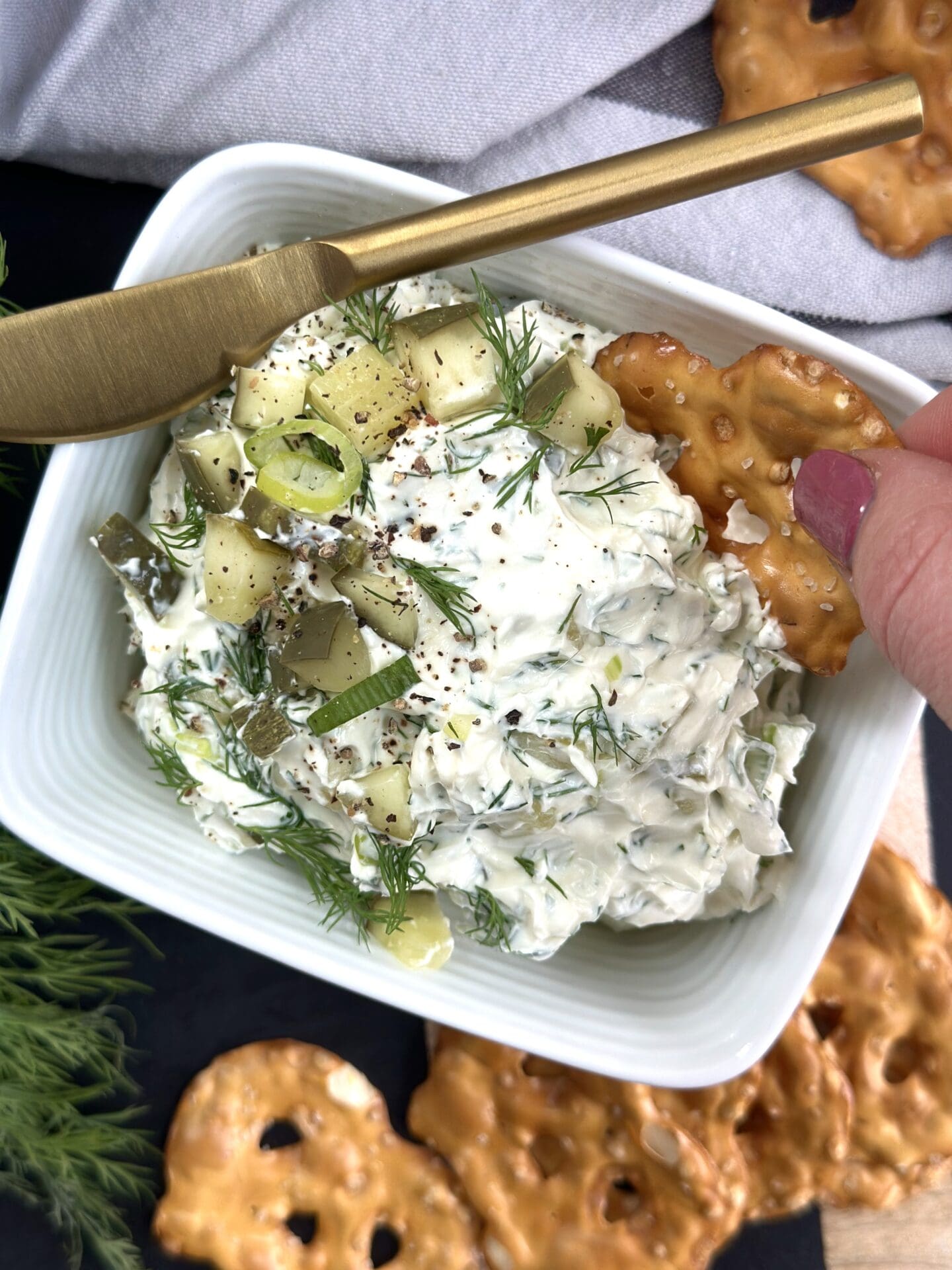 IMG_3296 A hand is seen dipping a pretzel chip into homemade Dill Pickle Dip