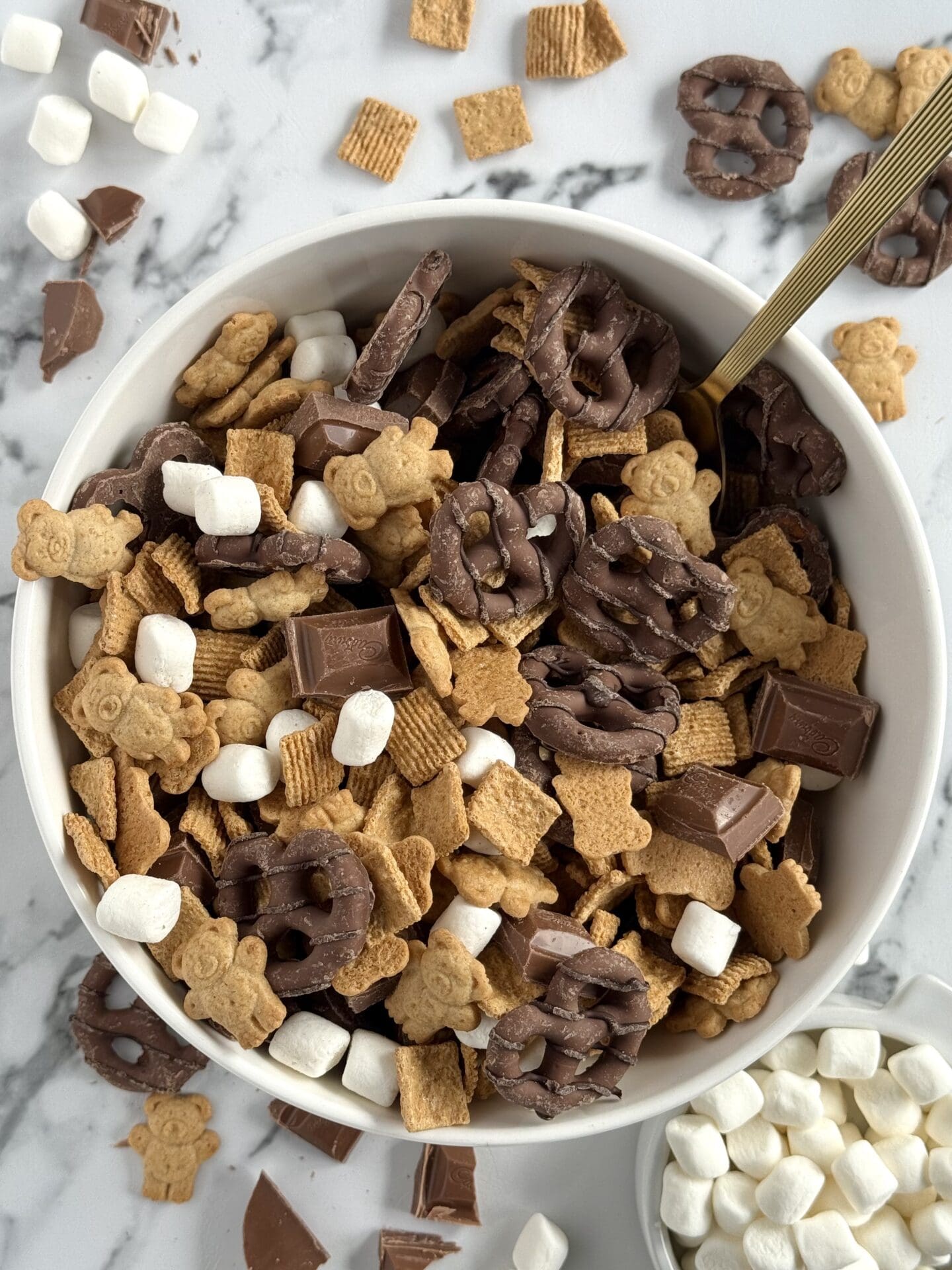 A bowl of S’Mores Snack Mix is seen from above, showing its delicious chocolate, marshmallow and graham cracker flavours as an easy, no-mess, snack mix.
