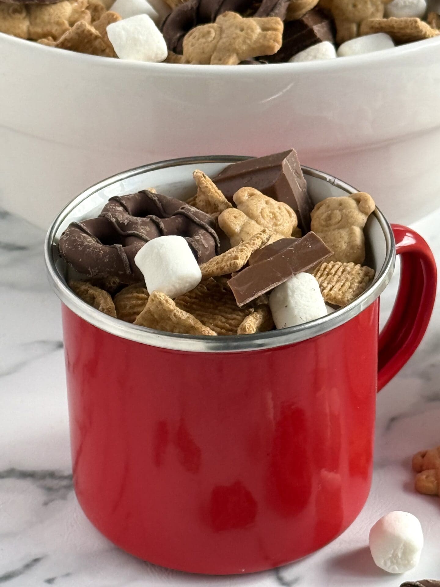 IMG_7056 A red enamel mug is filled with S’Mores Snack Mix, for an easy, portable versions of classic campfire s’mores.