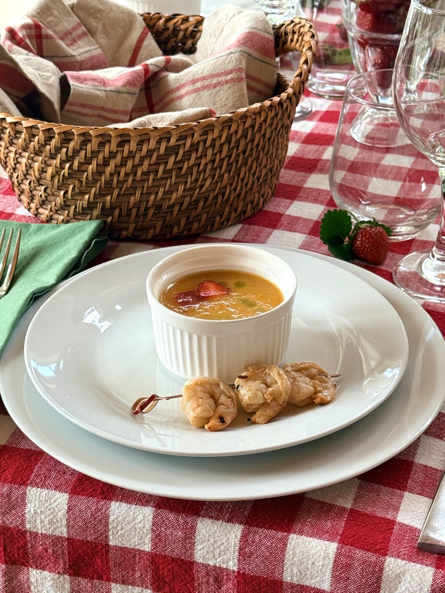IMG_9523 A small bowl of yellow tomato gazpacho is served as a first course alongside a skewer of spicy orange grilled shrimp.